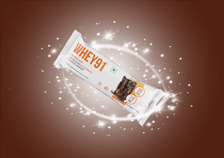 Whey91 choco fudge protein bar with 20g protein and 1.9g sugar, glowing sparkles on brown background